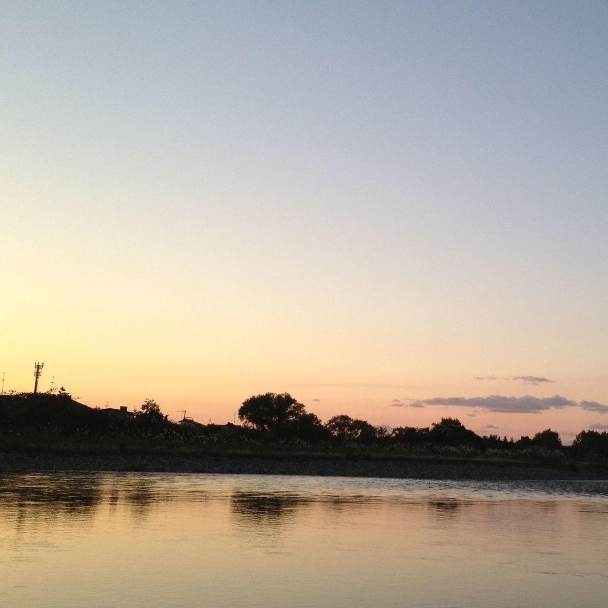 water, sunset, tranquil scene, silhouette, tranquility, scenics, waterfront, beauty in nature, copy space, clear sky, nature, lake, idyllic, reflection, sea, orange color, sky, dusk, calm, outdoors