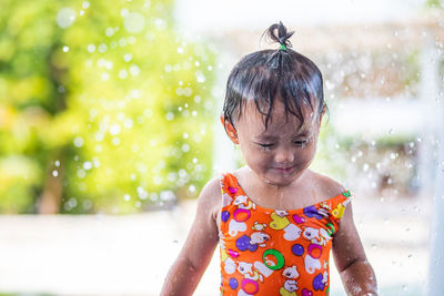 Cute girl standing at water park