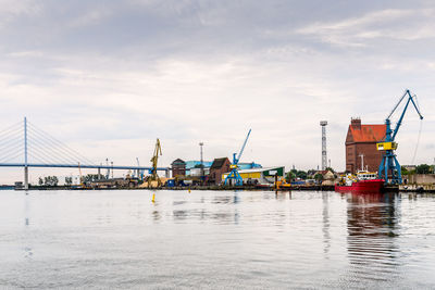 Panoramic view of the commercial harbour of stralsund with cranes and tugboat.