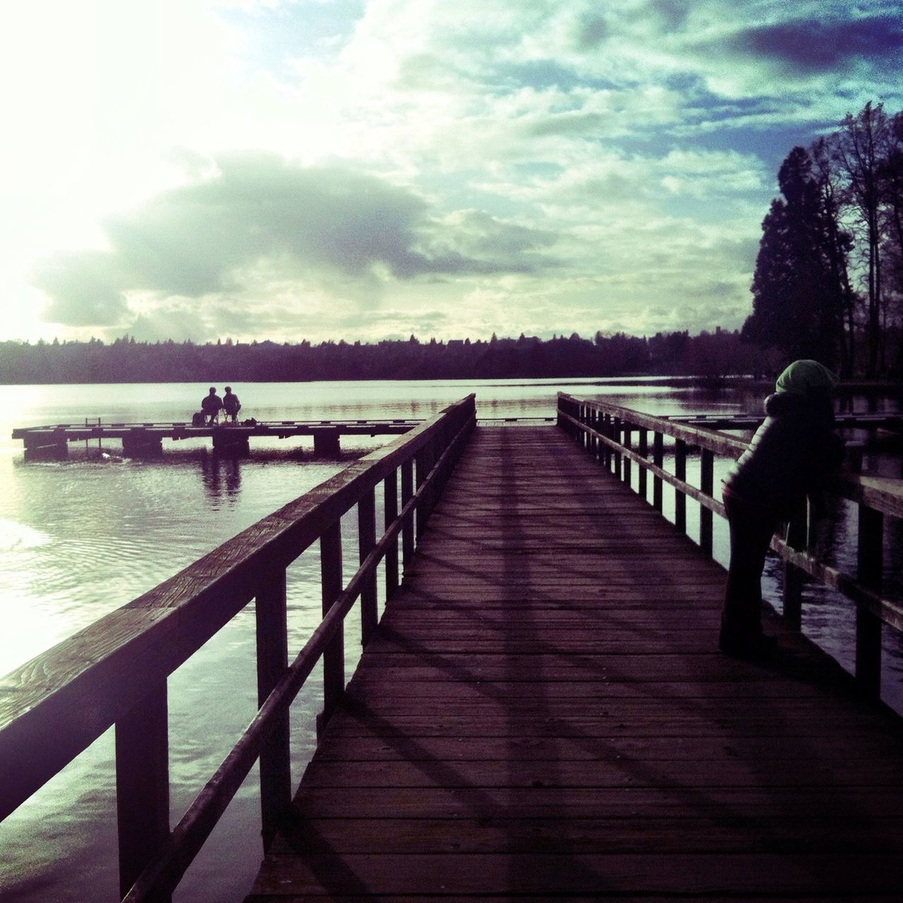 water, sky, railing, pier, silhouette, tranquil scene, tranquility, lake, cloud - sky, the way forward, scenics, nature, beauty in nature, bench, boardwalk, river, tree, cloud, men