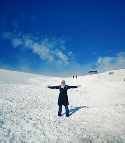 Full length of man standing on snow covered land