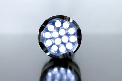 Close-up of illuminated electric lamp on table