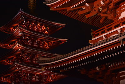 Low angle view of illuminated temples at night