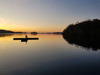 Scenic view of lake against sky during sunset