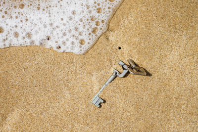 High angle view of keys on beach sand