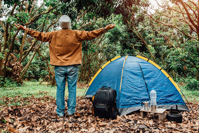 Rear view of man standing in tent