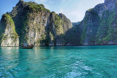 Scenic view of rock formation in sea against sky