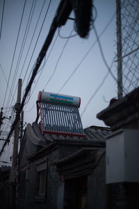 Low angle view of power lines against sky