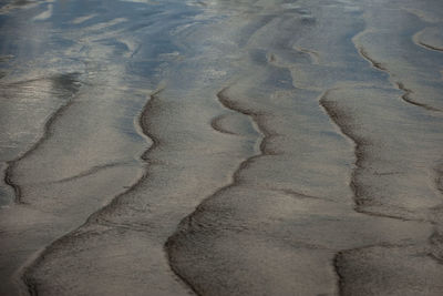 High angle view of footprints on sand at beach