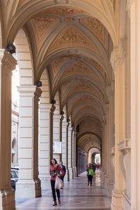 People walking in corridor of building