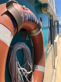 Close-up of life belt hanging on boat at beach