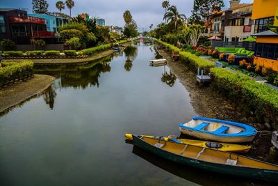 Boats in river with city in background