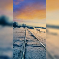 Close-up of railroad track against sky during winter