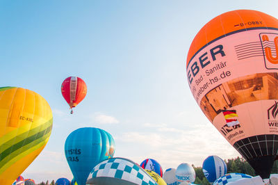 Low angle view of hot air balloons against sky