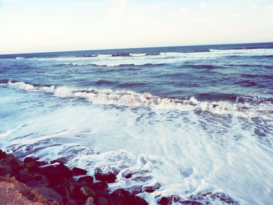 sea, water, horizon over water, wave, surf, scenics, beauty in nature, beach, motion, shore, nature, tranquil scene, sky, tranquility, rock - object, splashing, idyllic, seascape, remote, outdoors