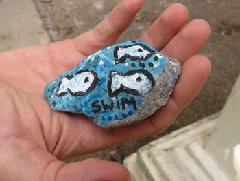 Close-up of person hand holding painting