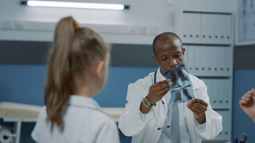 Female doctor examining chemical in laboratory