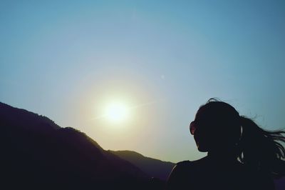 Man on mountain against sky during sunset