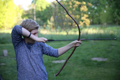 Boy holding boy and arrow