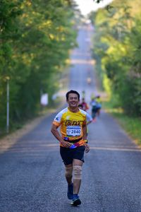 Man running on road in city