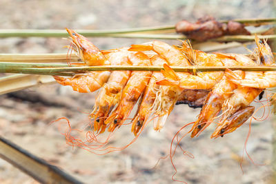 Close-up of orange berries on barbecue grill