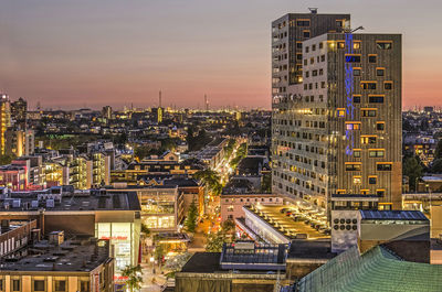 High angle view of illuminated buildings against sky at dusk