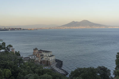 Scenic view of sea and buildings against sky