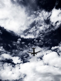 Low angle view of airplane flying in sky