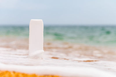 Close-up of drink on beach