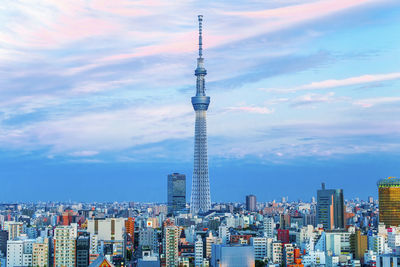 Tokyo sky tree tower in city against cloudy sky