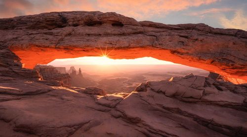 Scenic view of rock formations against sky during sunset