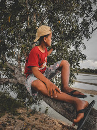 Portrait of boy sitting on field