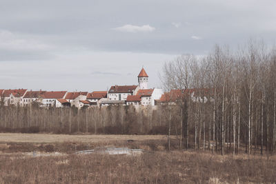 Houses on field against sky