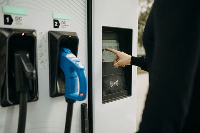 Man at electric charging station