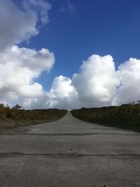 Empty road along countryside landscape