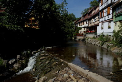 River amidst houses and buildings in city
