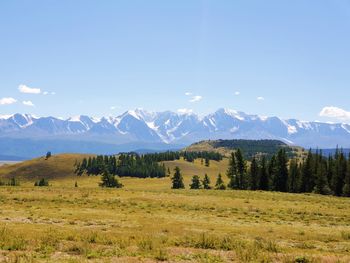 Scenic view of the landscape and the mountain range over the valley against the sky.