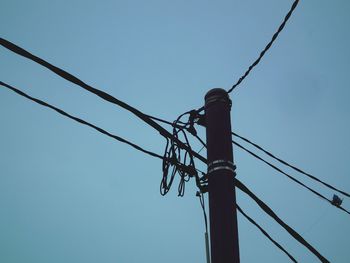 Low angle view of electricity pylon against sky