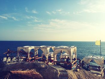 Chairs on beach against sky