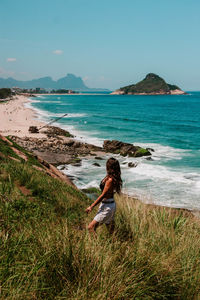 Woman looking at sea shore