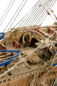 Low angle view of sailboats moored in water against sky