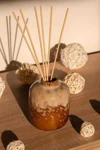 Cozy home decorations aroma reed diffuser in the living room. home comfort concept. bottle container