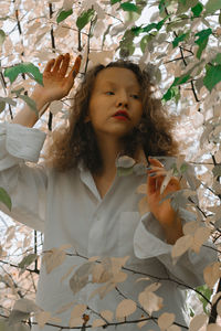 Portrait of woman against plants