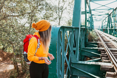Woman exploring trails and an old iron railroad bridge