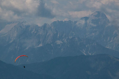 Person paragliding against sky