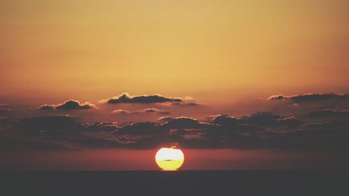 Scenic view of sea against romantic sky at sunset