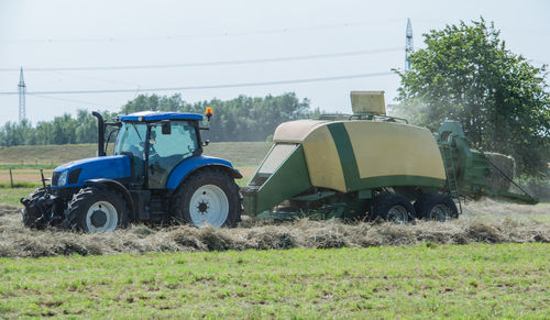 Tractor on field against sky