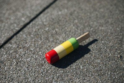 High angle view of colorful wooden toy on road during sunny day