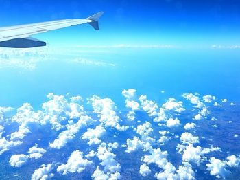 Aerial view of airplane flying over calm sea