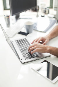 Close-up of man typing on laptop, new jersey, usa